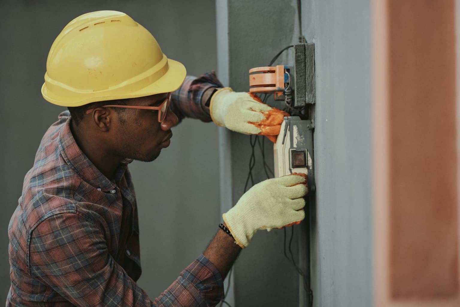 Utility technician working at a service panel